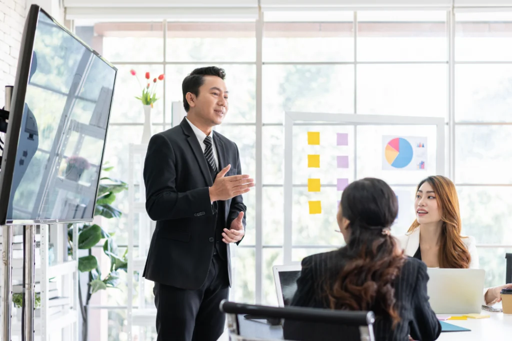 A Google Ads Specialist running a campaign meeting in a boardroom
