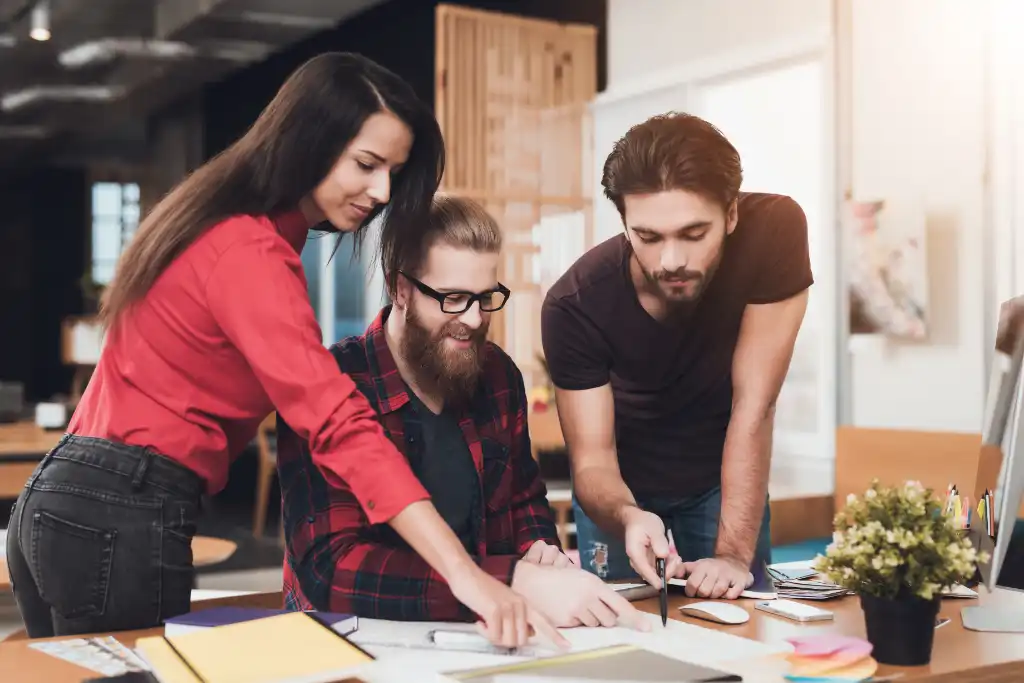 Account manager and copywriters reviewing copy together at a desk