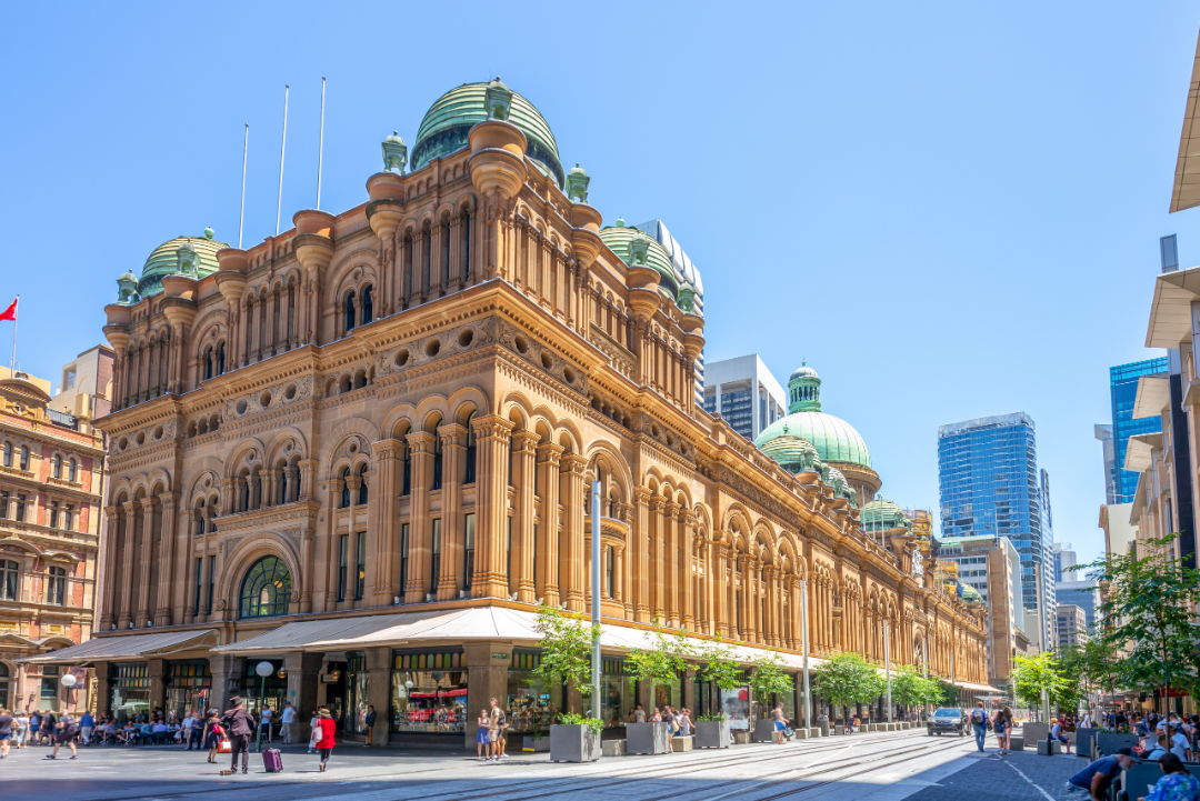 A street view of the Queen Victoria Building on a sunny afternoon